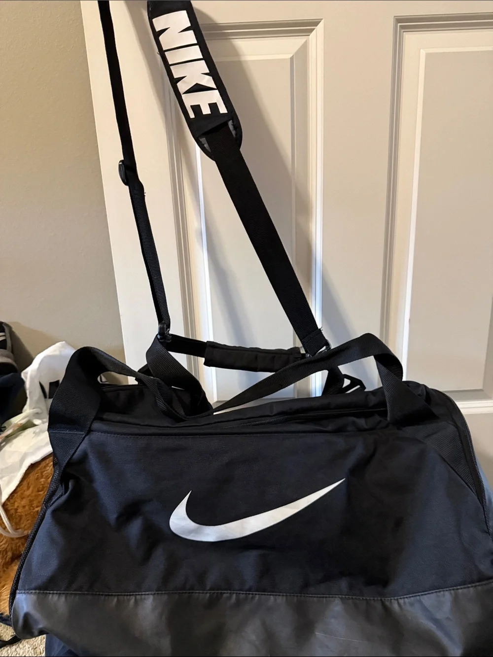 Nike Black Duffle Bag with White Swoosh and Adjustable Strap